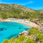 Cala Benirrás - Crystal-clear waters, sunlit shores, and rhythmic sunsets in Ibiza's coastal paradise.
