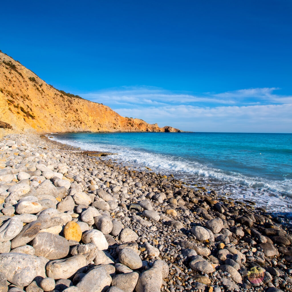 Rocky beach at Cala Jondal Ibiza with crystal-clear waters
