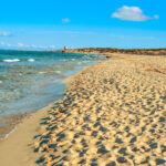 Beautiful view of Platja des Cavallet beach, Ibiza’s peaceful naturist beach with golden sands and clear waters