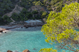 Fishermen huts at Es Portixol beach with rustic charm and coastal views