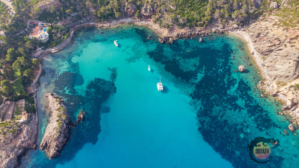 Aerial view of Es Canaret’s secluded cove with turquoise waters and lush surroundings in Ibiza